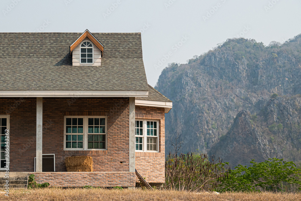 Brick house with hay in the farm with mountain view