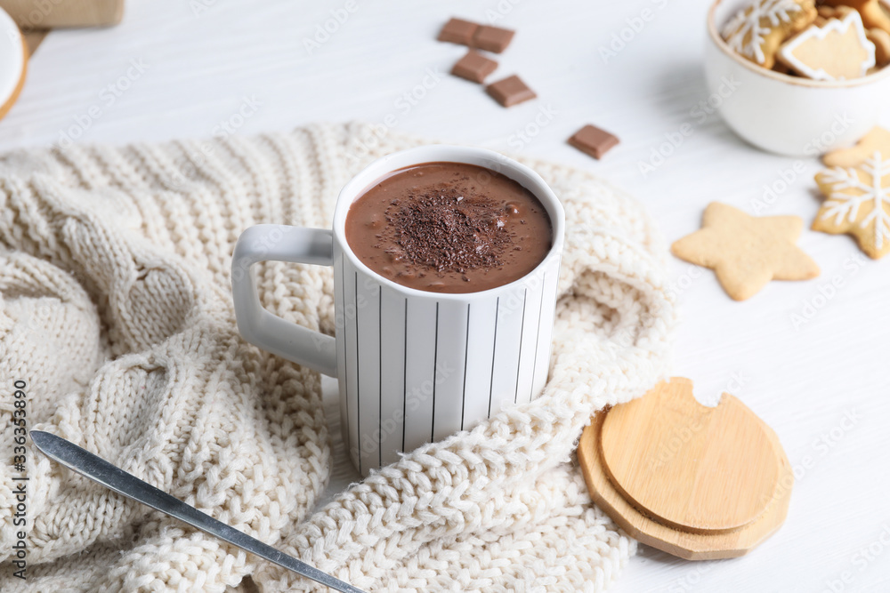 Cup of hot chocolate and cookies on table