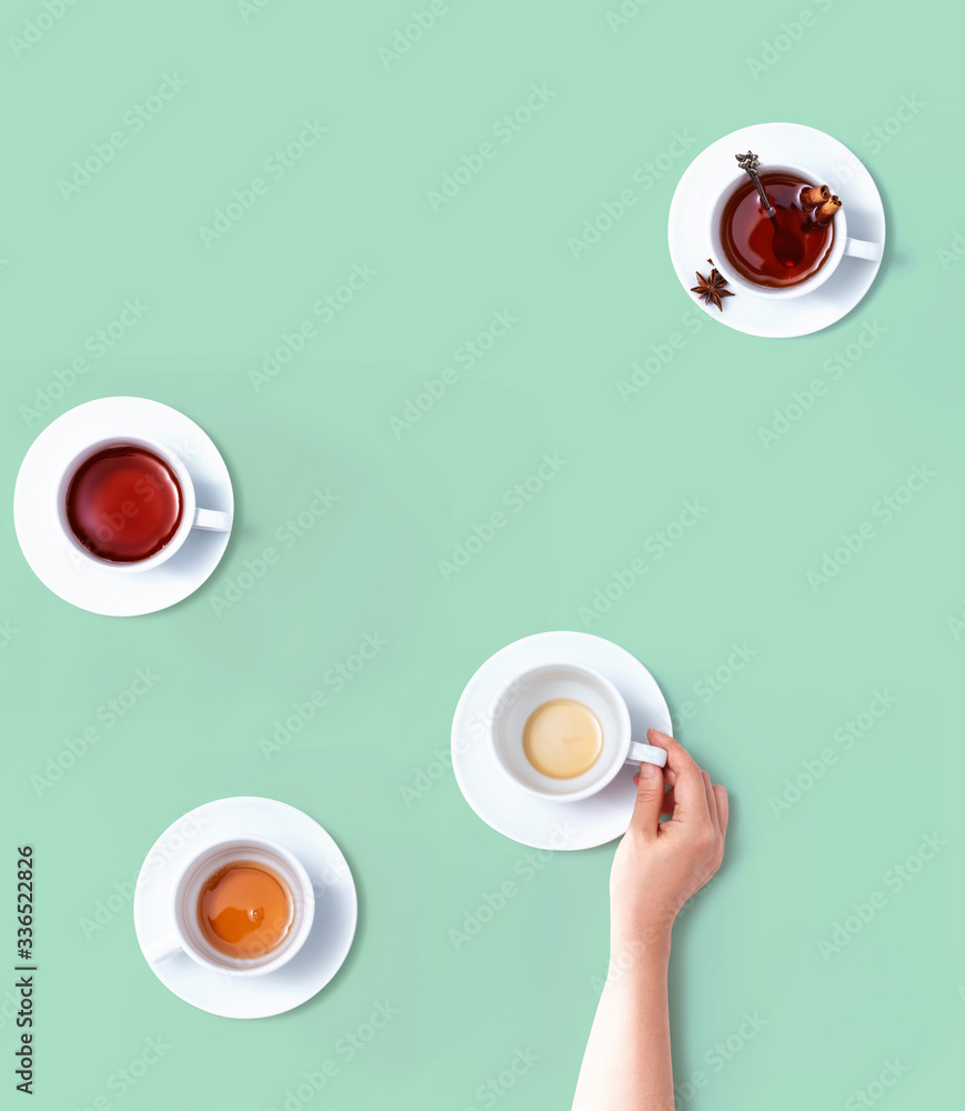 Female hand holding a tea cup overhead view - flat lay