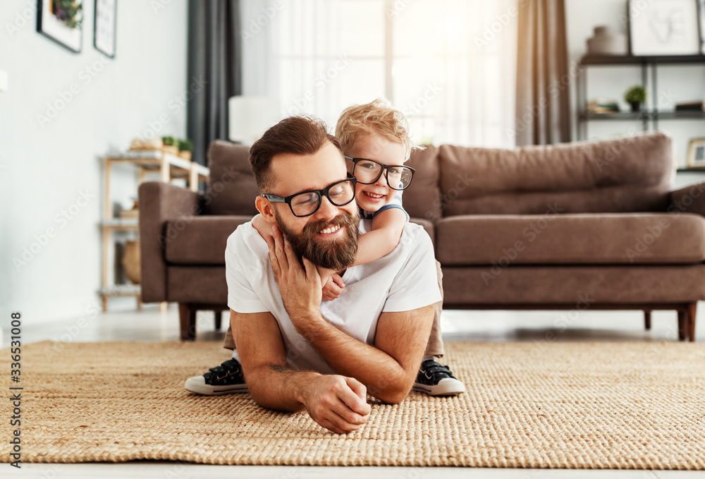 Father and little son having fun at home