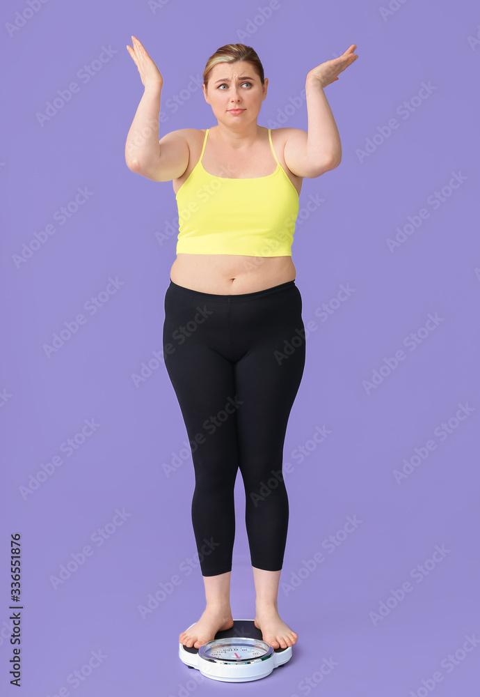 Displeased overweight woman on scales against color background. Weight loss concept