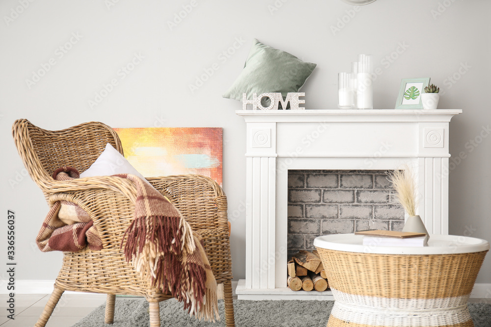 Interior of modern room with comfortable armchair and fireplace