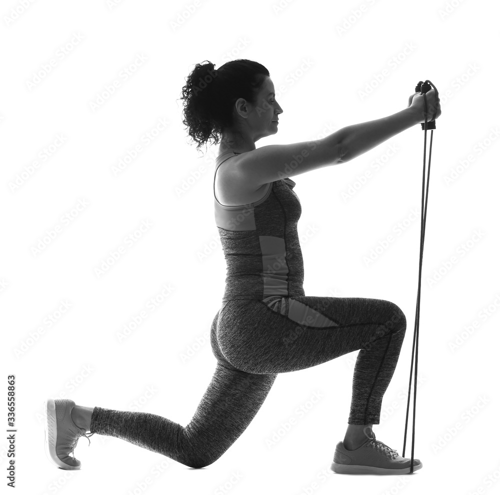 Silhouette of sporty young woman training against white background