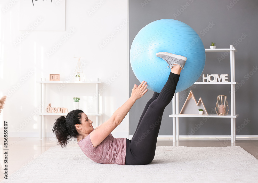 Sporty young woman training at home