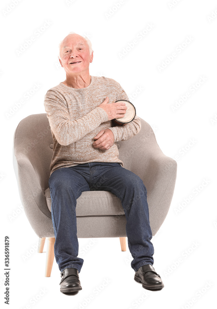 Portrait of elderly man playing drum on white background