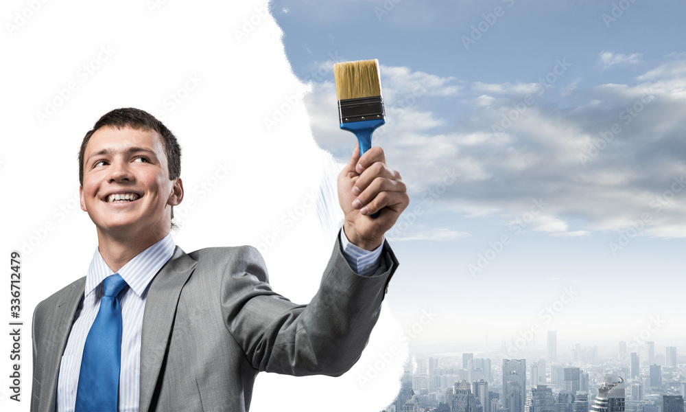 Creative businessman painter holding paintbrush