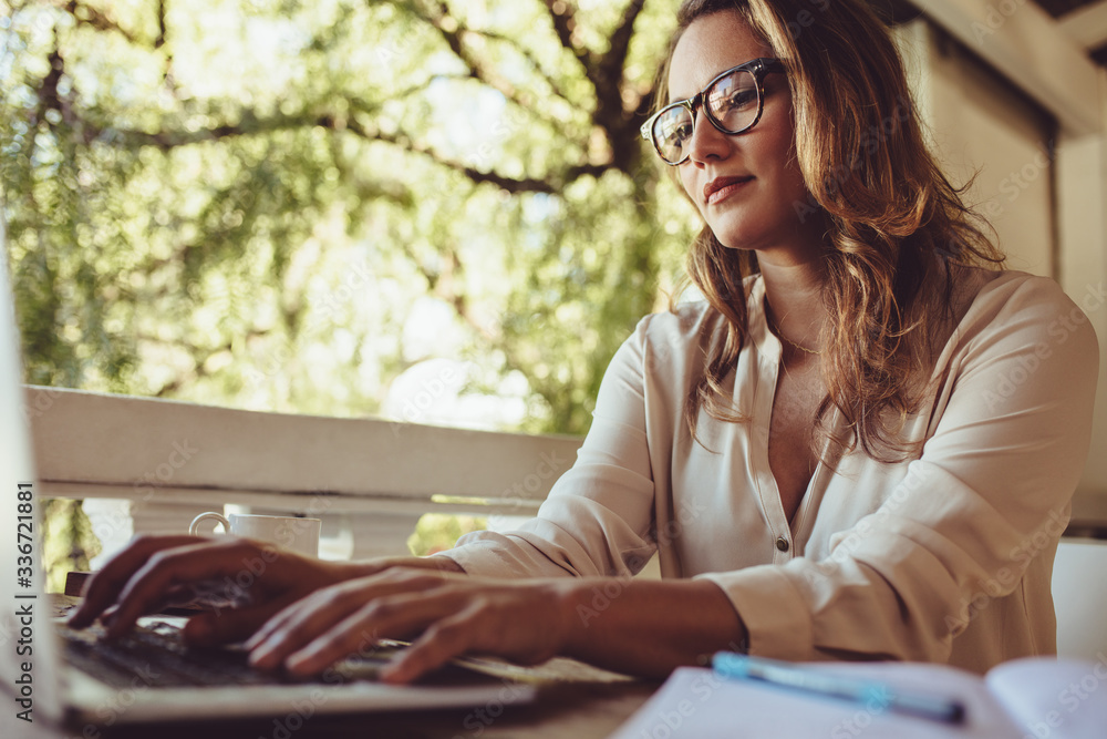 Businesswoman at cafe working on laptop