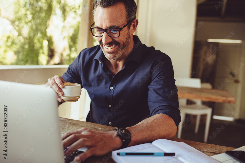 Man doing his work sitting at a coffee shop