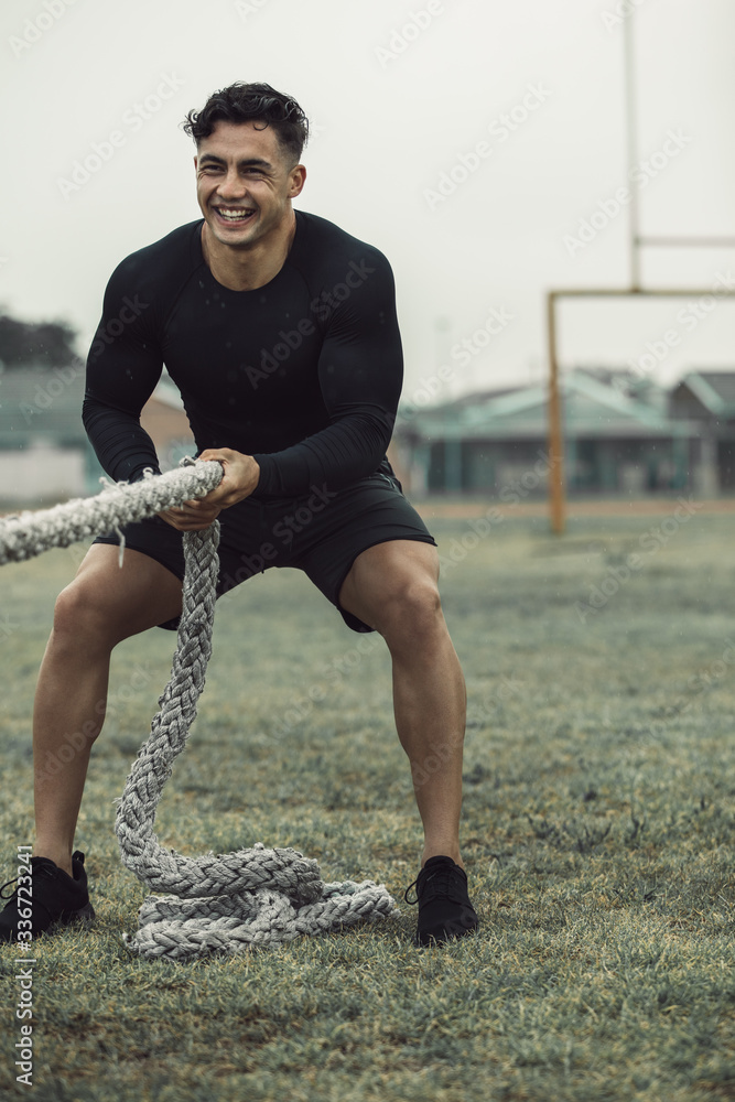 Man training with battle ropes