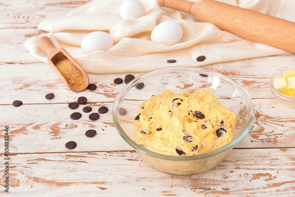 Bowl with sweet dough on table