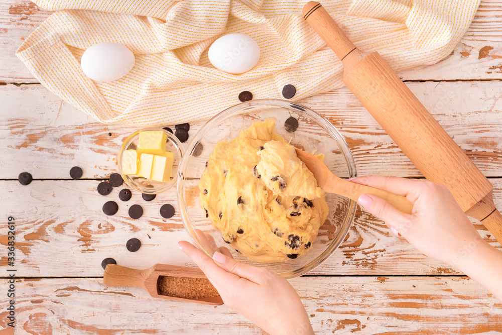 Woman preparing sweet dough, top view