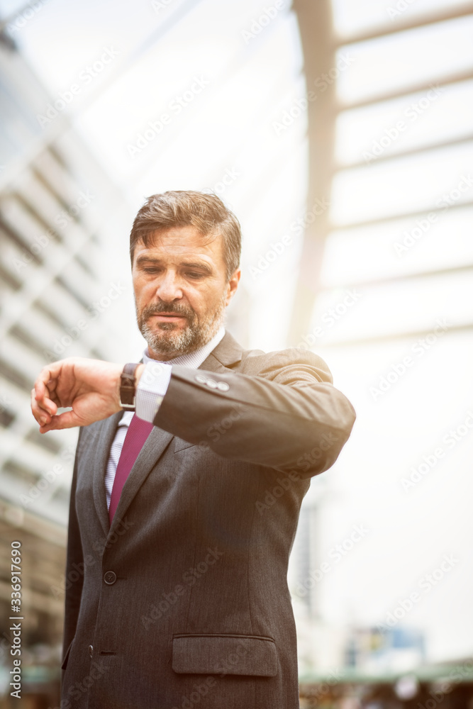 Busy businessman checking his watch