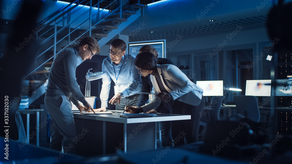 Diverse Team of Electronics Development Engineers Standing at the Desk Working with Documents, Solvi