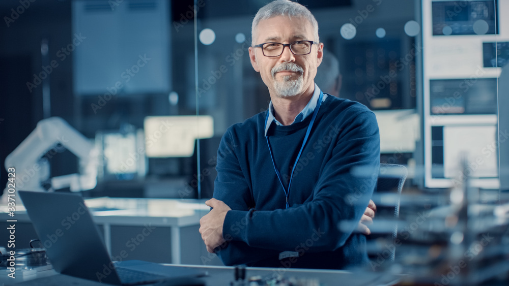 Professional Electronics Design Engineer Wearing Glasses Works on Laptop Computer in Research Labora