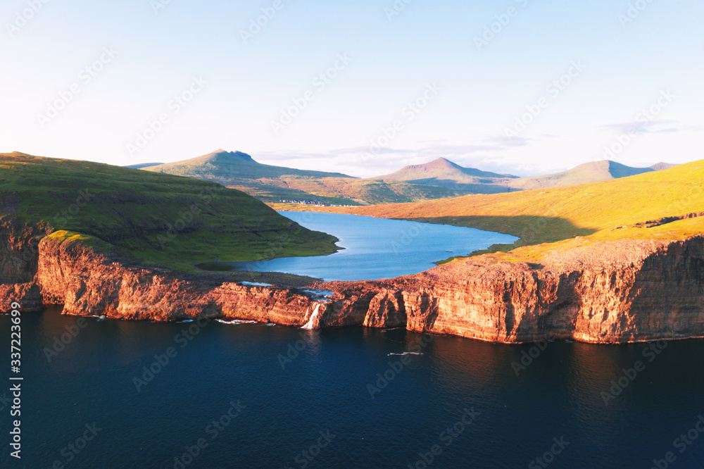 Aerial view from drone of Sorvagsvatn lake on cliffs of Vagar island in sunset time, Faroe Islands, 