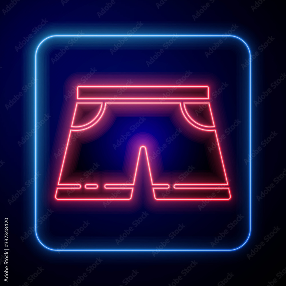 Glowing neon Swimming trunks icon isolated on blue background. Vector Illustration