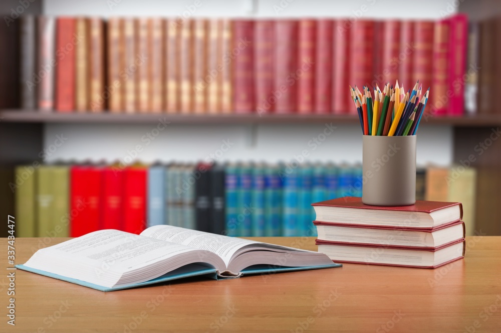 Stack school books with color pencil on desk