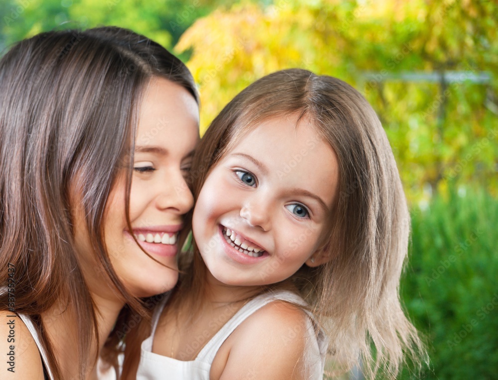 Happy smiling mother and daughter hugging