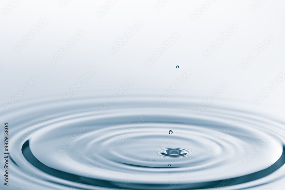 Waves on the surface of the water from a collision. Drop of water drop to the surface.