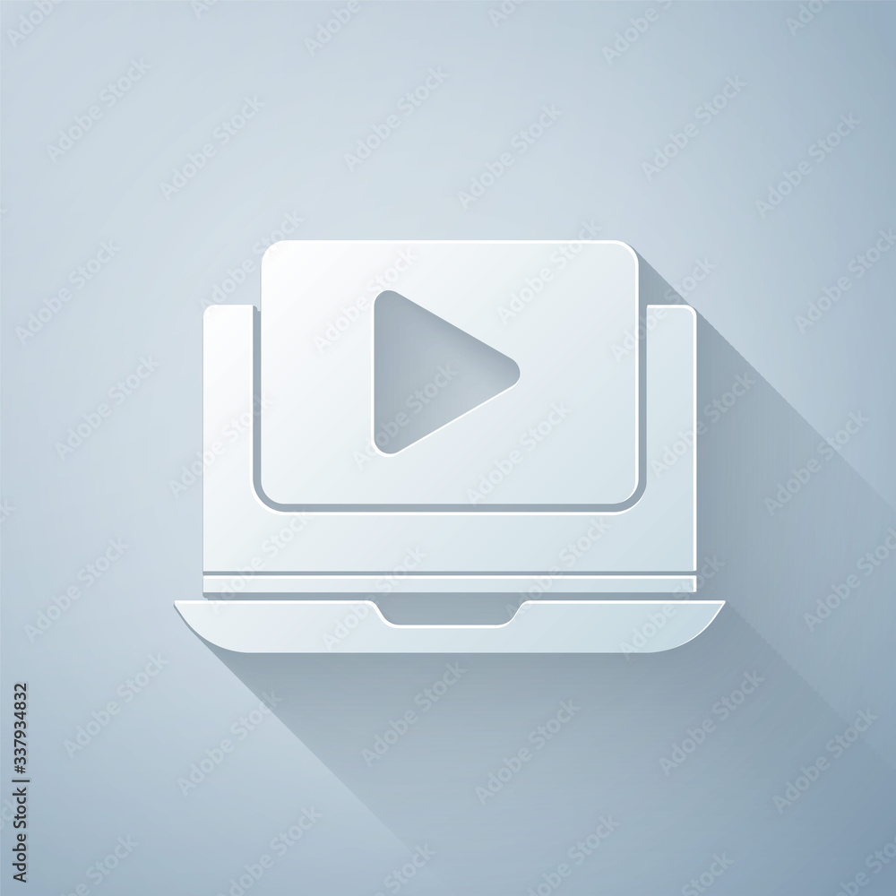 Paper cut Online play video icon isolated on grey background. Laptop and film strip with play sign. 