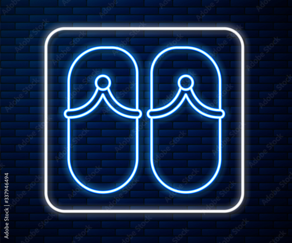 Glowing neon line Flip flops icon isolated on brick wall background. Beach slippers sign. Vector Ill