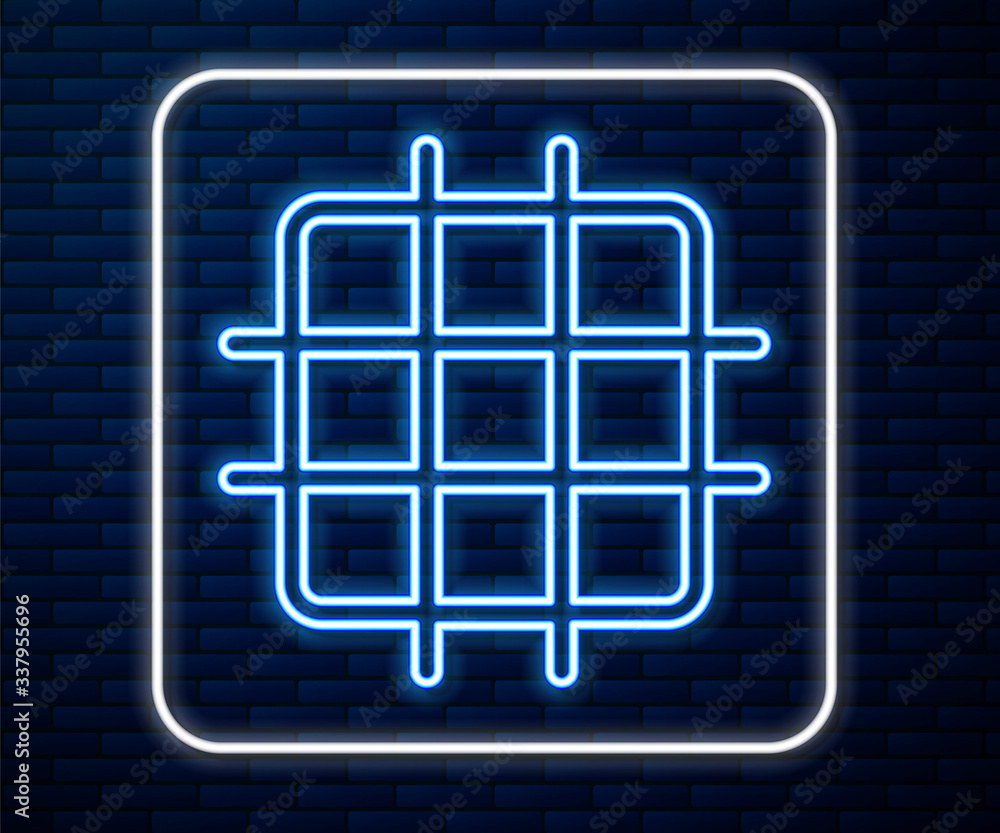 Glowing neon line Grid graph paper icon isolated on brick wall background. Vector Illustration