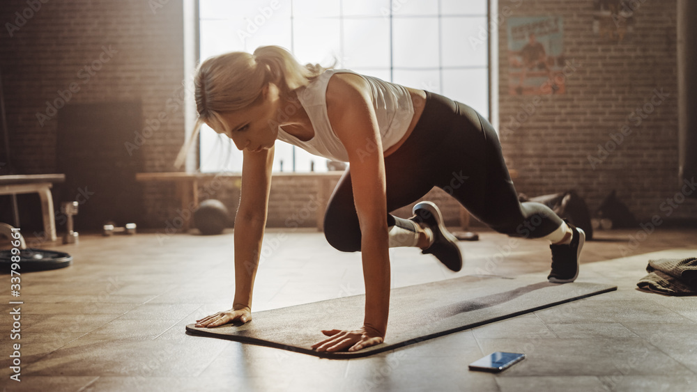 Beautiful and Young Girl Doing Running Plank on Her Fitness Mat. Athletic Woman Does Mountain Climbe