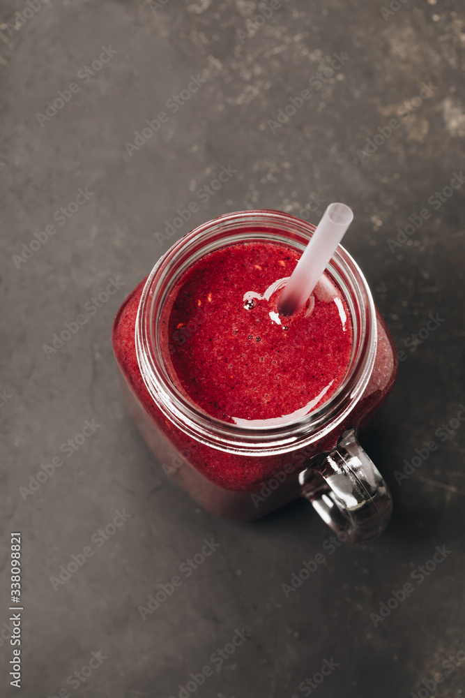 Berry smoothie on rustic background, top view