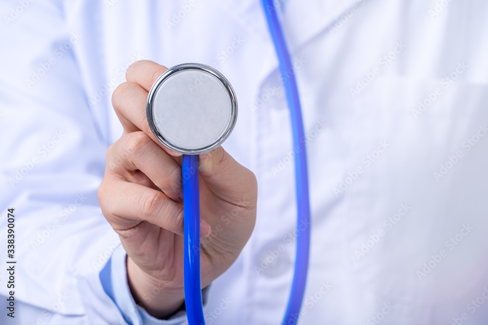 Female doctor portrait, young woman physican holding a stethoscope isolated on white background, clo