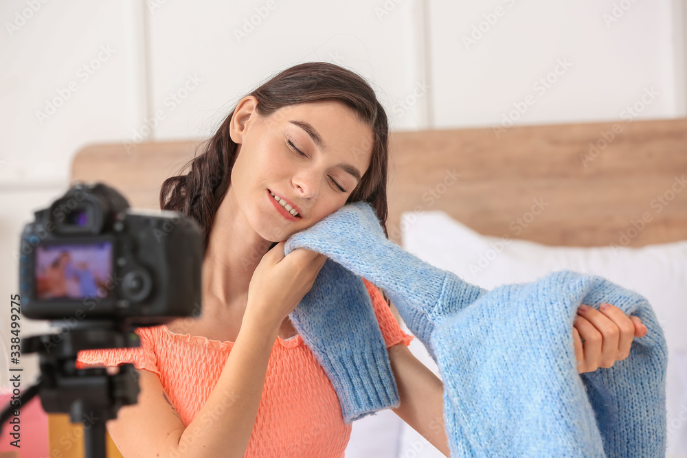 Young fashion blogger recording video at home