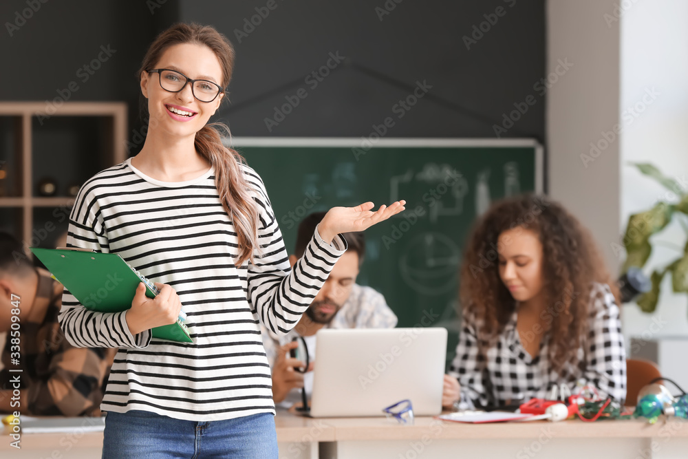 Young woman at physics lesson in classroom