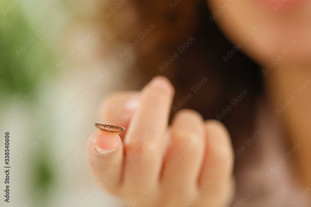 Young African-American woman with contact lens at home, closeup