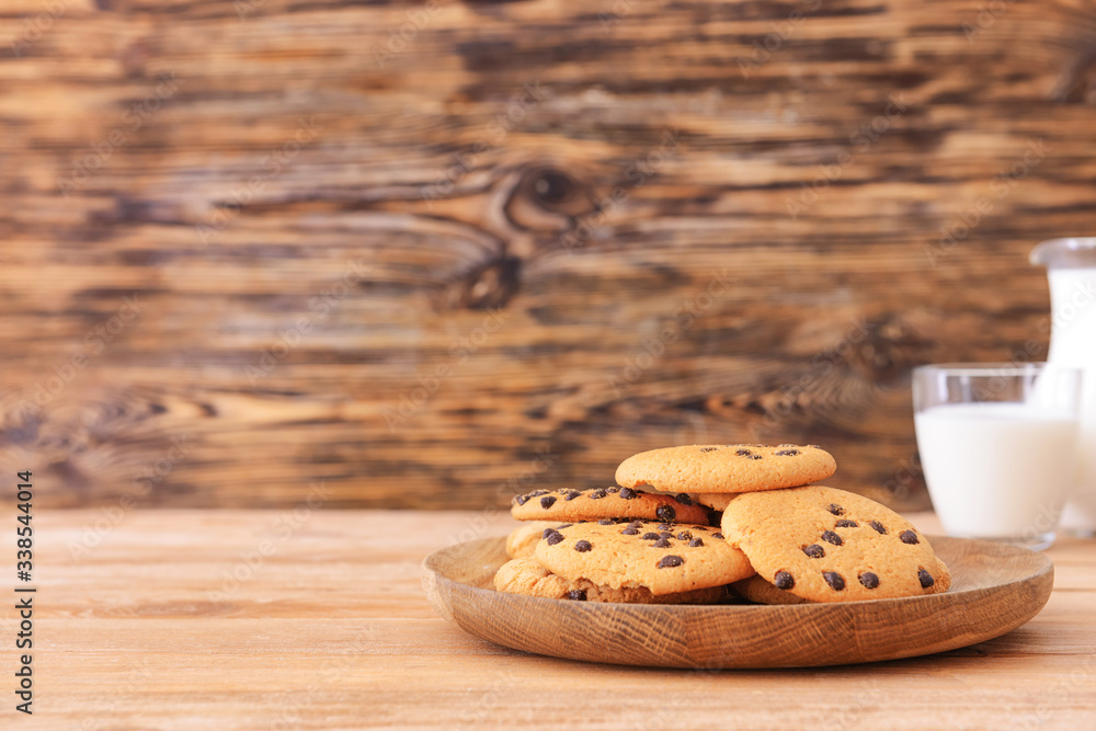 Plate with sweet cookies on table