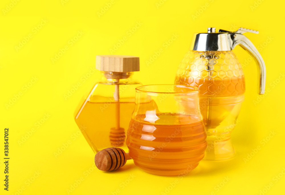 Glassware of sweet honey on color background