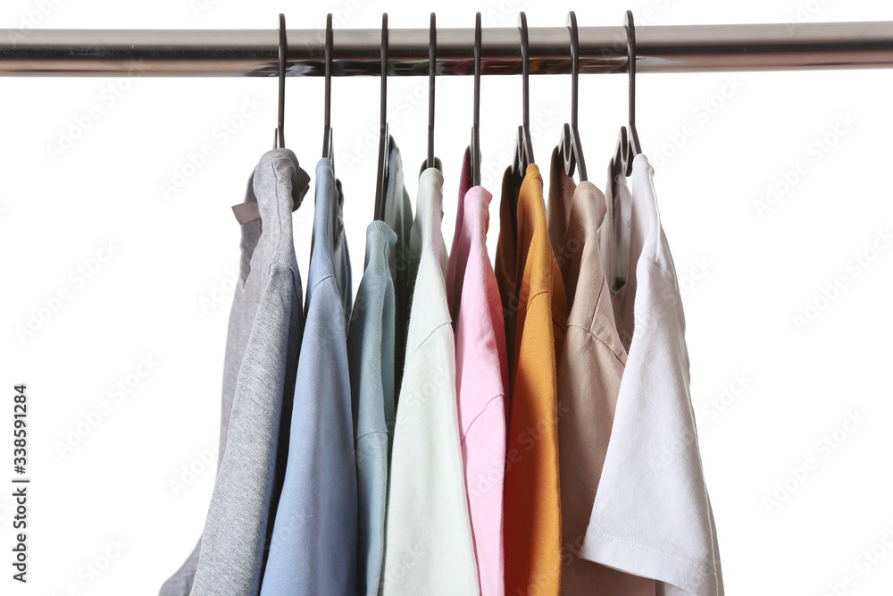 Rack with modern clothes on white background