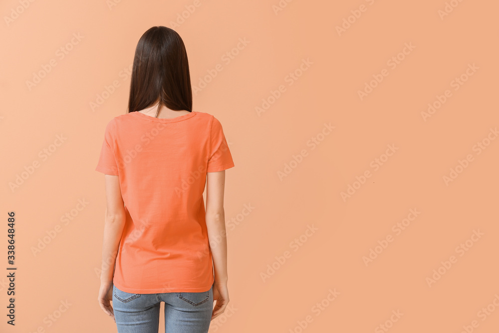 Woman in stylish t-shirt on color background