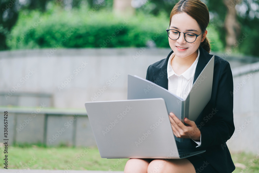 A business woman working in the park