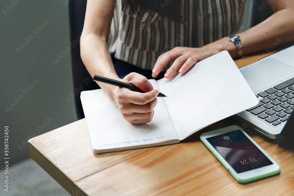 Woman writing on notebook