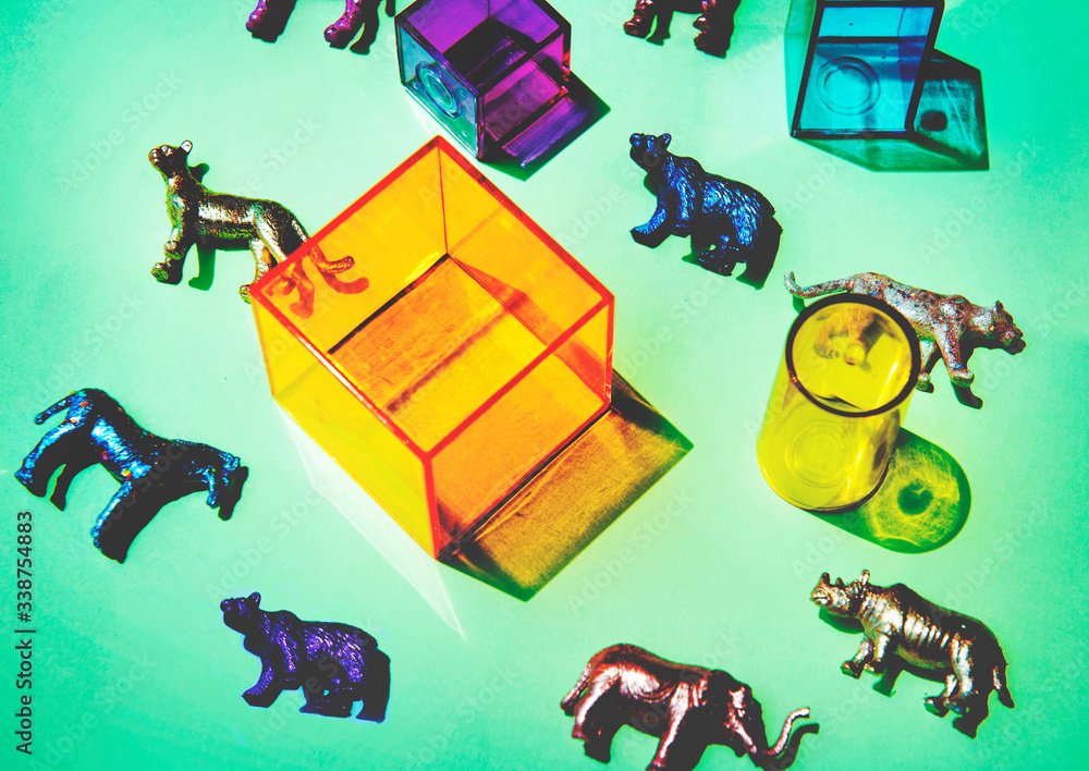 Various animal toy figures with boxes and in a colorful background