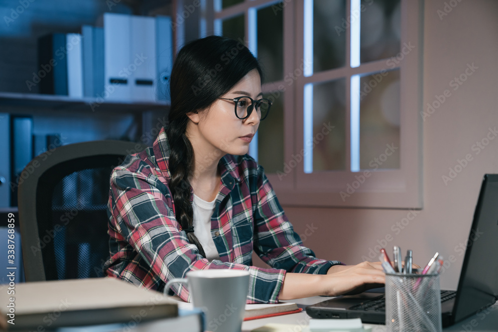 young asian korean girl student working on laptop computer at night at home. smart woman study in co