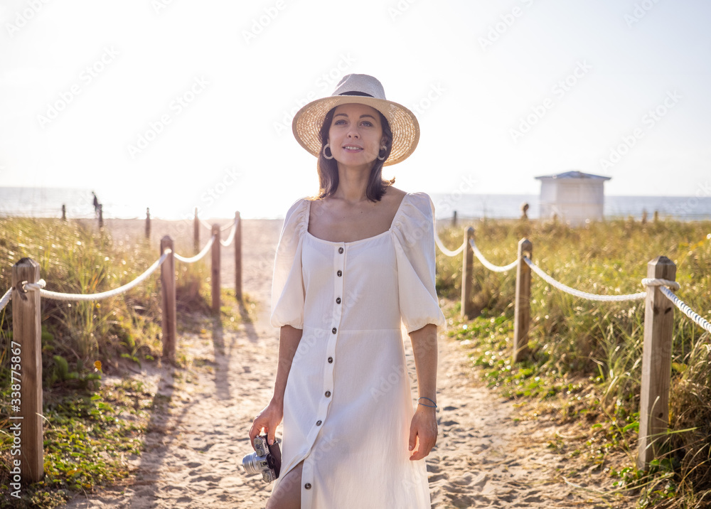 Beautiful young girl in a white dress outdoors