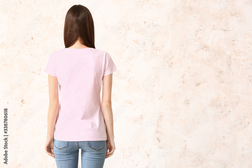 Woman in stylish t-shirt on light background