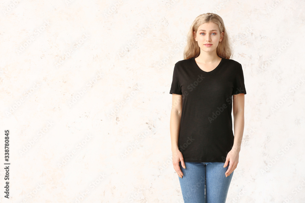 Woman in stylish t-shirt on light background