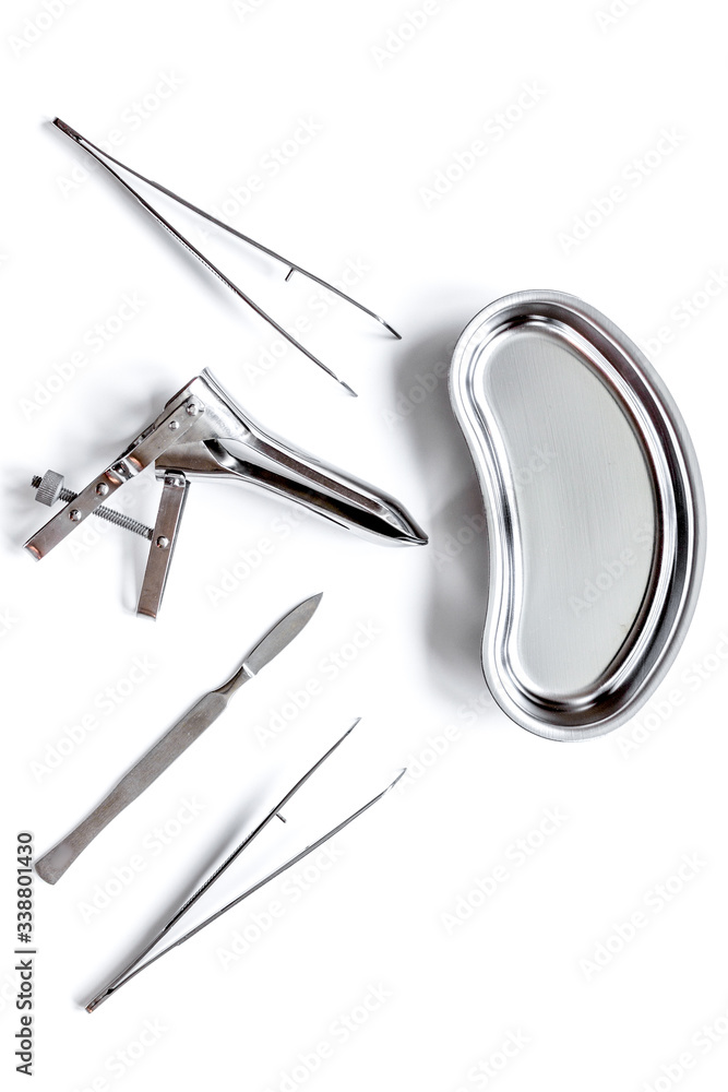 instruments of gynecologist on white background top view