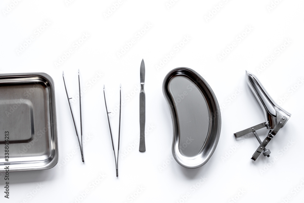 instruments of gynecologist on white background top view