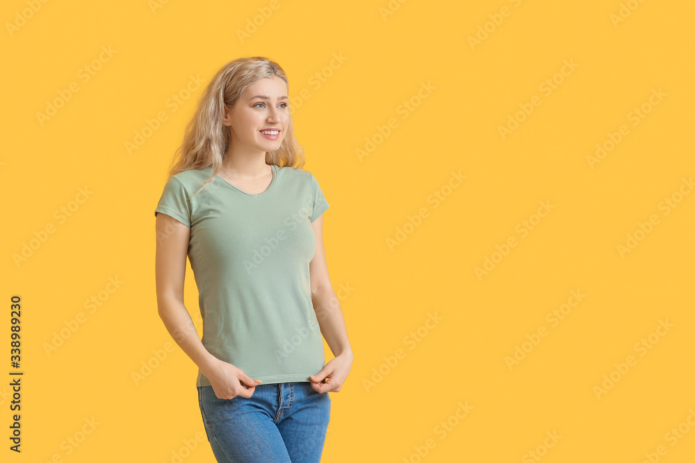 Woman in stylish t-shirt on color background