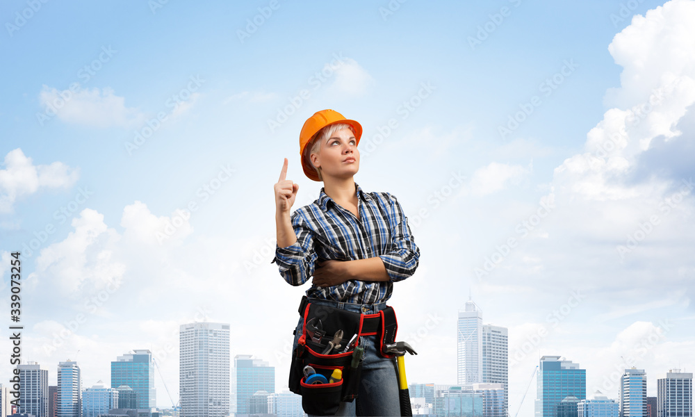 Beautiful female builder in hardhat