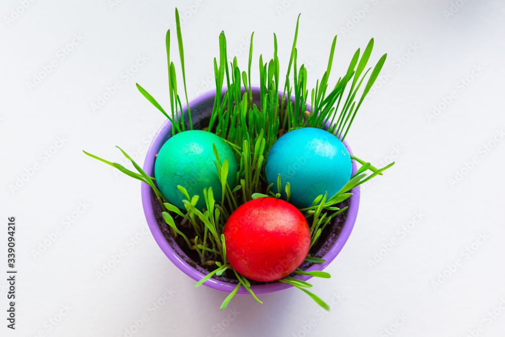 Painted Easter eggs in a bowl with grass