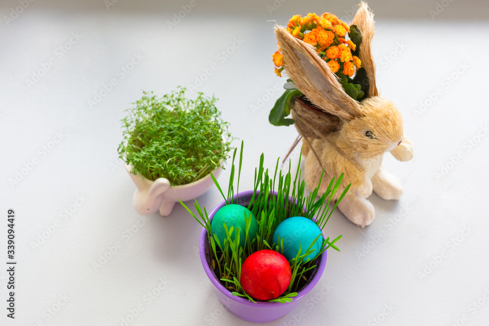 Painted Easter eggs in a bowl with grass