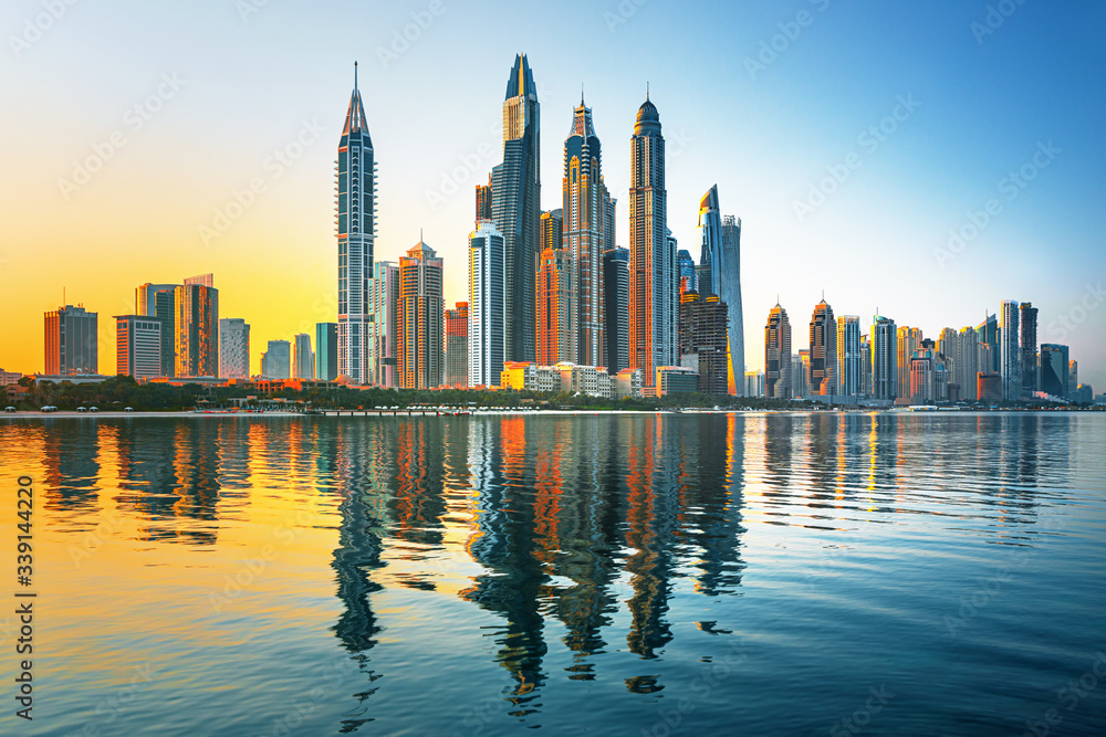 Modern and Luxury Dubai Marina with reflection - famous Jumeirah beach at sunrise, United Arab Emira